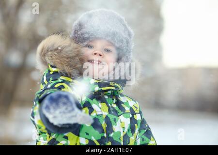 walking funny little boy in the winter. child outdoors. Stock Photo