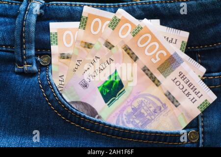 Ukrainian money. New banknotes five hundred hryvnia bills UAH in the back pocket of blue jeans. Money concept, Corruption Stock Photo