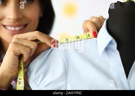 Joyful professional dressmaker at work Stock Photo