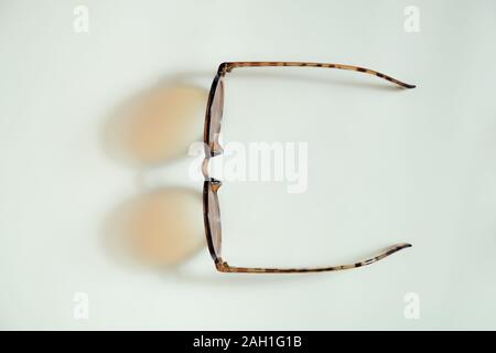 Sunglasses dropping shadows on white background. Concept of vacation, summer rest or holidays Stock Photo