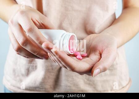 Taking pills or nutritional supplements, close-up view. Tablets in a human hand, concept of taking a medication or taking prescription drugs Stock Photo