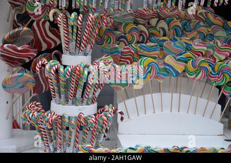 Colorful lollipops and different colored round candy. Birthday, striped. Spiral Fruit Lollipops. Stock Photo