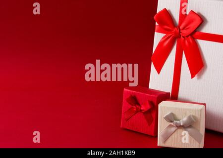 White and red gift boxes on red background. Copy space Stock Photo