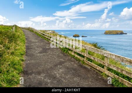 Cliffs of Carrick-a-rede rope bridge in Ballintoy, Co. Antrim. Landscape of Northern Ireland.Traveling through the Causeway Coastal Route. Stock Photo