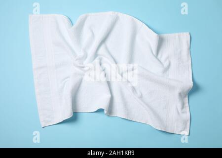 White crumpled towels on blue background, top viewWhite crumpled towels on blue background, top view Stock Photo