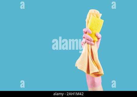 Hand of housewife showing kitchen soap and microfiber cloth she is using for cleaning the house Stock Photo