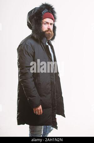 Hipster winter fashion. Guy wear black winter jacket with hood