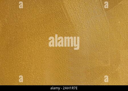 Wall painted in gold color pattern texture background Stock Photo