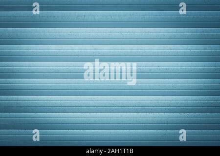 Blue metallic jalousie. Texture of corrugated metal surface. Dirty ribbed background with straight lines. Striped wall, space. Exterior element Stock Photo