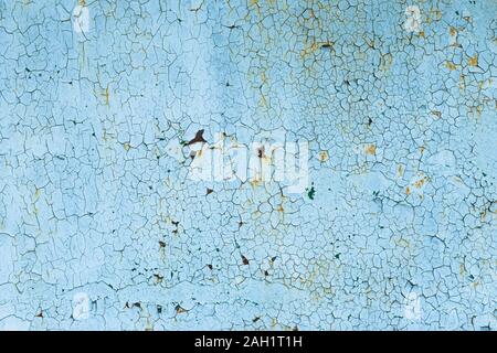 Peeling paint on rusty steel door. Corrosion on a metal surface. Abstract background, texture. Blue cracked painted wall Stock Photo