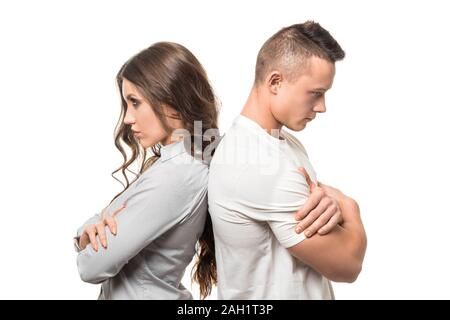 Portrait of upset unhappy couple standing back to back holding arms crossed ignoring each other isolated on white background. negative emotion, family Stock Photo