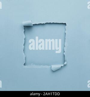Pastel blue torn paper square frame.Background of the gap openings with copy space for text. Minimal abstract colorful Wallpaper concept Stock Photo