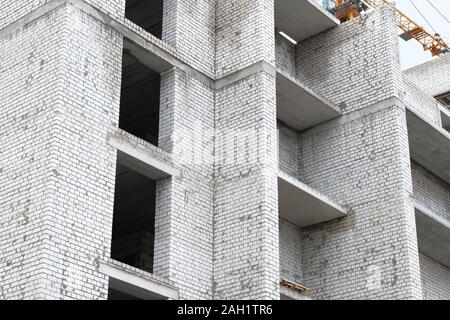 Facade of many story house under construction. House under construction at building site. Building and Construction site of new home. Stock Photo