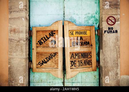 Detail Old western swinging Saloon doors.With spanish text. No smoking ,Billiard and entrance prohibited for children under 18 years. Stock Photo
