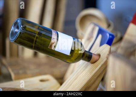 bottle of wine in a wooden stand Stock Photo