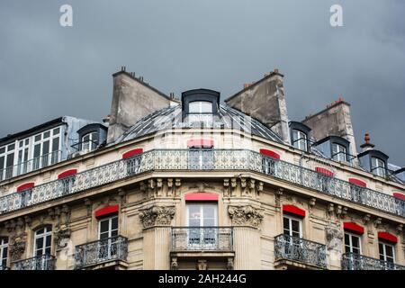 Classical Parisian style residential building, with typical European architecture, with gray sky in the background Stock Photo