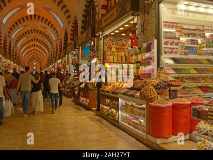 Istanbul, Turkey - September 19th 2019. Tourists walk past shops selling spices, teas and dried fruit in the historic Egyptian Spice Bazaar in Eminonu Stock Photo