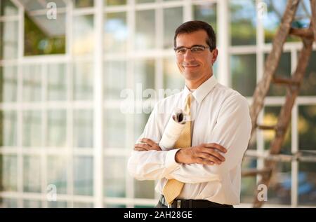 Construction worker writing on a blueprint. Stock Photo