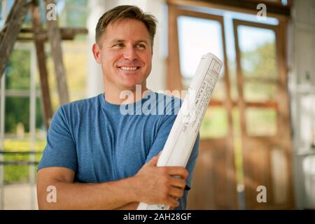 Two businessmen looking at samples on a construction site. Stock Photo