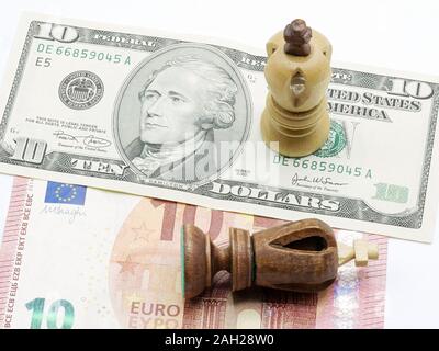 Trade Concept: King Chess Pieces On US Dollar And Euro Banknotes, Isolated On White Background, USA winning Stock Photo