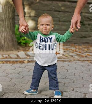 Portrait of a young boy holding hands with his parents. Stock Photo