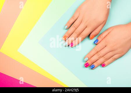 Neon manicure on multicolored bright background in trendy colors. Flat lay style. Stock Photo