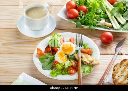 Healthy breakfast in european or american style with boiled eggs, vegetables and herbs. Copy spase Stock Photo