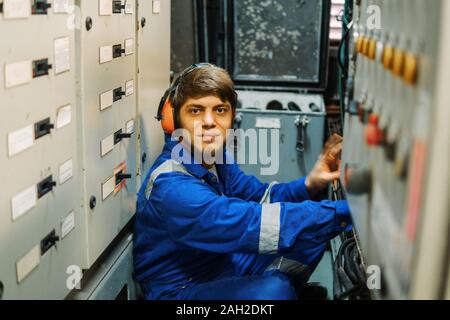 Marine engineer inspecting ship's engine or generators Stock Photo