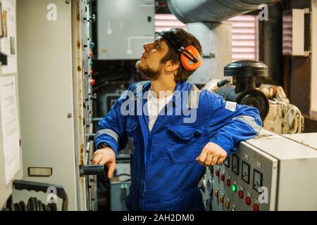 Marine engineer inspecting ship's engine or generators Stock Photo