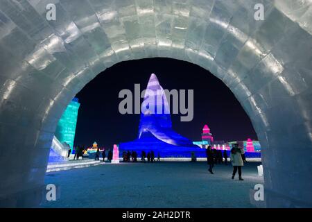 Harbin, China's Heilongjiang Province. 23rd Dec, 2019. People visit the 21st Ice-Snow World in Harbin, capital of northeast China's Heilongjiang Province, Dec. 23, 2019. Credit: Xie Jianfei/Xinhua/Alamy Live News Stock Photo