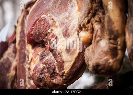 Serbian ham, called prsut, italian style, similar to prosciutto crudo, hanging in the countryside of Serbia. Prosciutto is a typical dry cured meat of Stock Photo