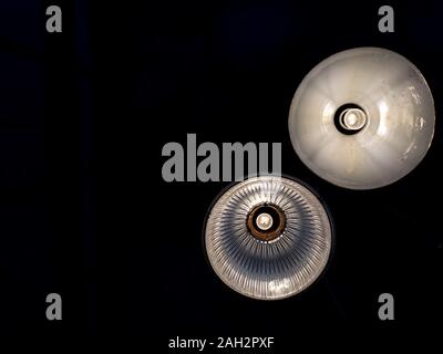 Ceiling light retro style hanging from ceiling in dark room with copy space, view from the bottom. Stock Photo