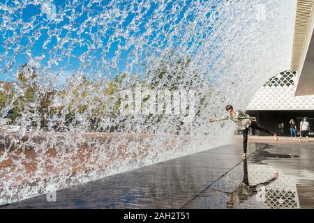 Lisbon, Portugal - october 10, 2017: People walk under the fountain in the Park of the Nations,  Lisbon, Portugal. Stock Photo