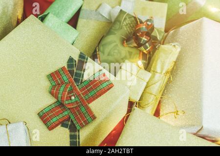 Beautiful various gifts boxes or presents in different size and shape with ribbon on table in the party Stock Photo