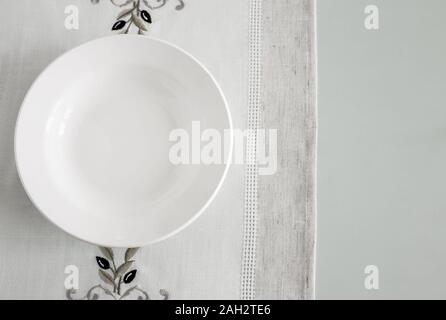 A white empty plate on a linen napkin Stock Photo