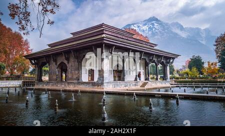 Mughal Heritage Building with snoe covered Zabarwan Mountains in the background during Autumn in Shalimar Bagh Mughal Garden of Kashmir Stock Photo