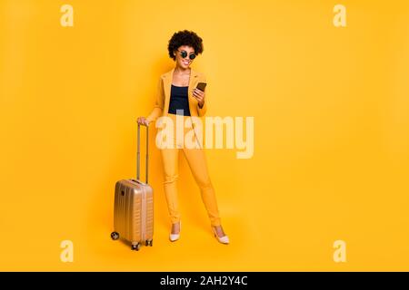 Tourism concept full body photo of positive brown curly hair lady use smartphone find way gps have summer weekend wear blazer trousers high-heels hold