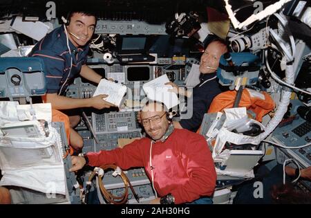 (31 July-8 Aug 1992) --- The 'blue-shift' crew members pose on the flight deck of the Earth-orbiting Space Shuttle Atlantis.  Left to right are Andrew M. Allen, pilot; Franco Malerba, representing the Italian Space Agency (ASI) and Swiss scientist Claude Nicollier, representing the European Space Agency (ESA). Stock Photo