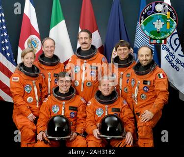 (May 1992) --- The crew members assigned to the STS-46 mission pose with seven flags that represent participation on the flight. Loren Shriver (right front) is mission commander; Andrew Allen (left front) is pilot. Others are (left to right) Marsha Ivins, mission specialist; Claude Nicollier, mission specialist representing the European Space Agency (ESA); Jeffrey Hoffman, payload commander; Franklin Chang-Diaz, mission specialist; and Franco Malerba, flying for the Italian Space Agency (ASI). The flags, left to right, represent the United States of America, Costa Rica (Chang's native country) Stock Photo