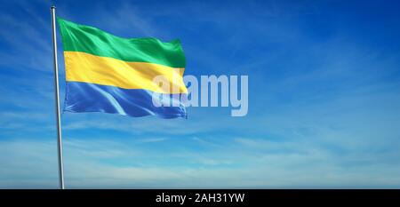 The National flag of Gabon blowing in the wind in front of a clear blue sky Stock Photo