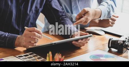 Close-up view of young male graphic designer editing their work with tablet in workplace Stock Photo