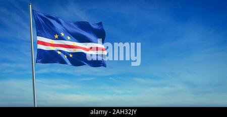 The National flag of Cape Verde blowing in the wind in front of a clear blue sky Stock Photo