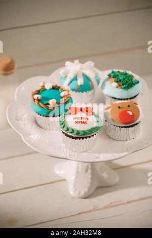 Beautiful Christmas cupcakes decorated fairy-tale figures close-up on the table. horizontal Stock Photo