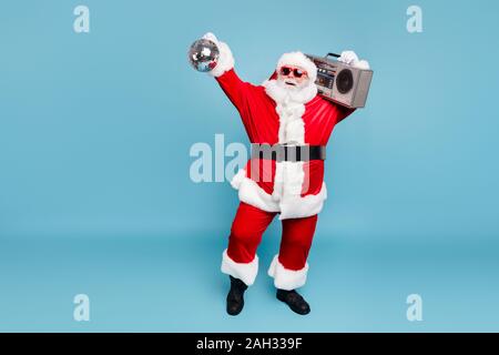 Full length body size view of his he nice cool fat cheerful cheery glad carefree bearded Santa carrying tape player dancing holding in hand discoball Stock Photo