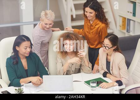 Horizontal shot of five successful female office workers having online meeting with their foreign business partner Stock Photo