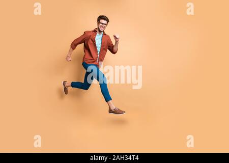 Full length body size view of nice attractive cheerful cheery strong sportive successful guy leader jumping in air running fast hurry-up meeting Stock Photo