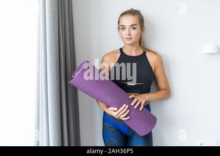 Sporty Attractive Slim Woman Holding Yoga Mat before or after Fitness  Class. Active Yogi Girl Ready for Yoga and Sport Exercise To Stock Image -  Image of exercise, asian: 167557657