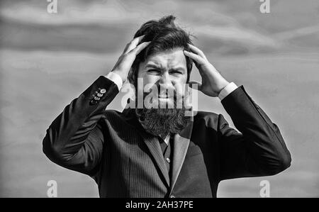Stressful business. Pain and migraine. Frustration and disappointment. Unforgivable mistake. Business failure. Man bearded stressful painful face sky background. Guy suffer headache stressful day. Stock Photo
