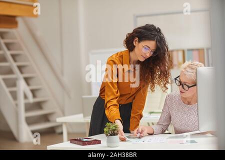 Horizontal shot of two female clothes designers working together on new fashion collection Stock Photo