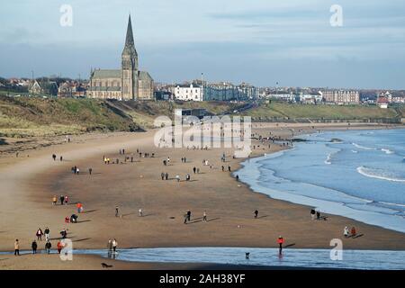 People walk on the beach at Tynemouth Long Sands ahead of the Christmas holiday. Stock Photo